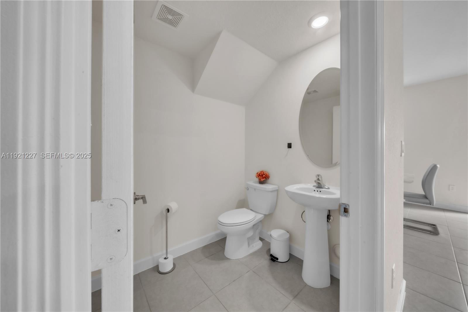 12917 Northwest 23rd Place Miami, FL 33147 - Photo 16 of 43 a bathroom with a toilet sink and mirror