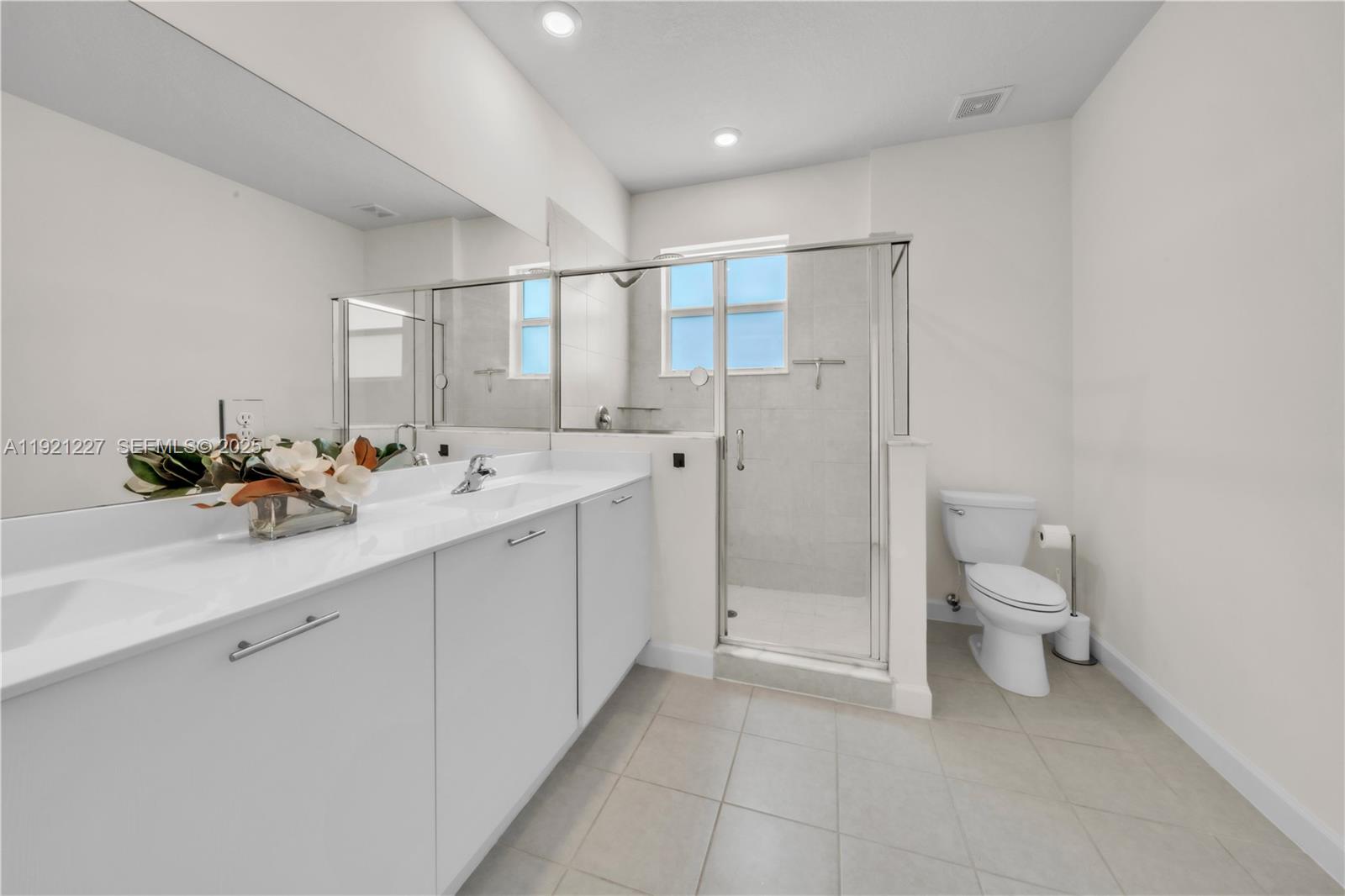 12917 Northwest 23rd Place Miami, FL 33147 - Photo 22 of 43 a bathroom with a double vanity sink and a toilet