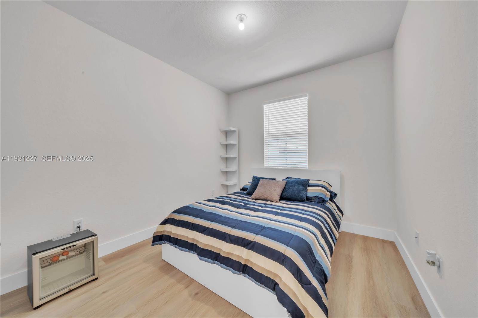 12917 Northwest 23rd Place Miami, FL 33147 - Photo 26 of 43 a bedroom with a bed and a window