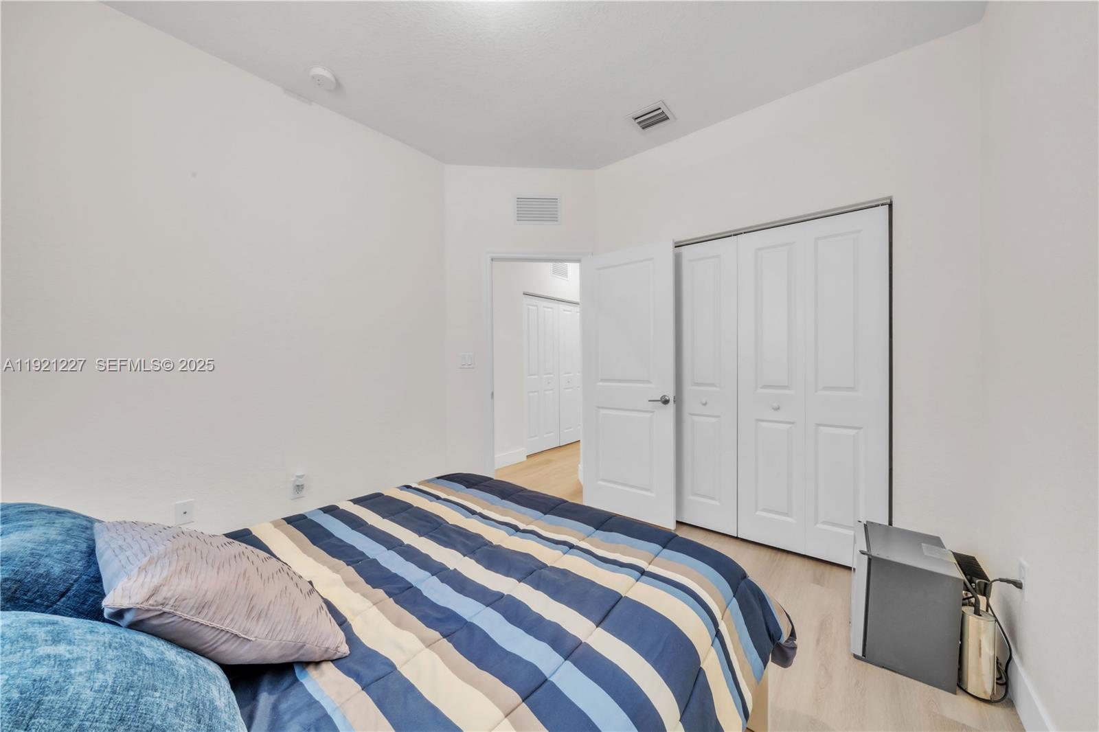 12917 Northwest 23rd Place Miami, FL 33147 - Photo 27 of 43 a bedroom with a bed and a couch