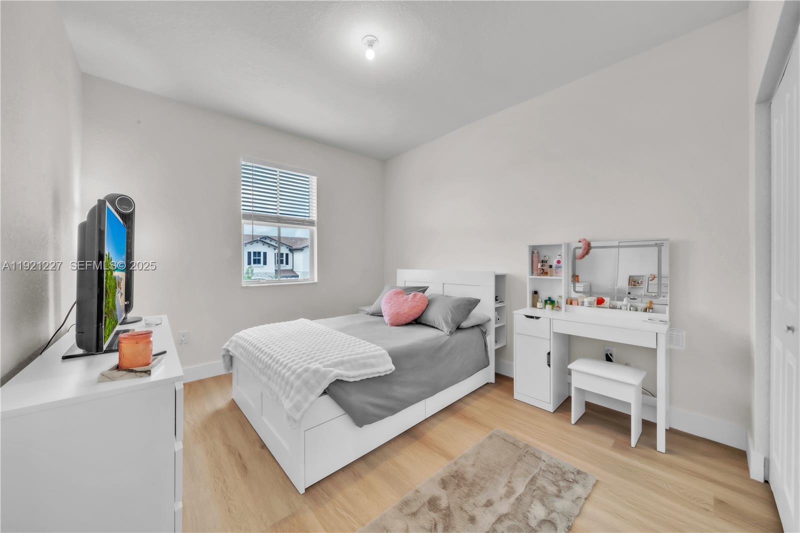 12917 Northwest 23rd Place Miami, FL 33147 - Photo 28 of 43 a bedroom with a bed and a window