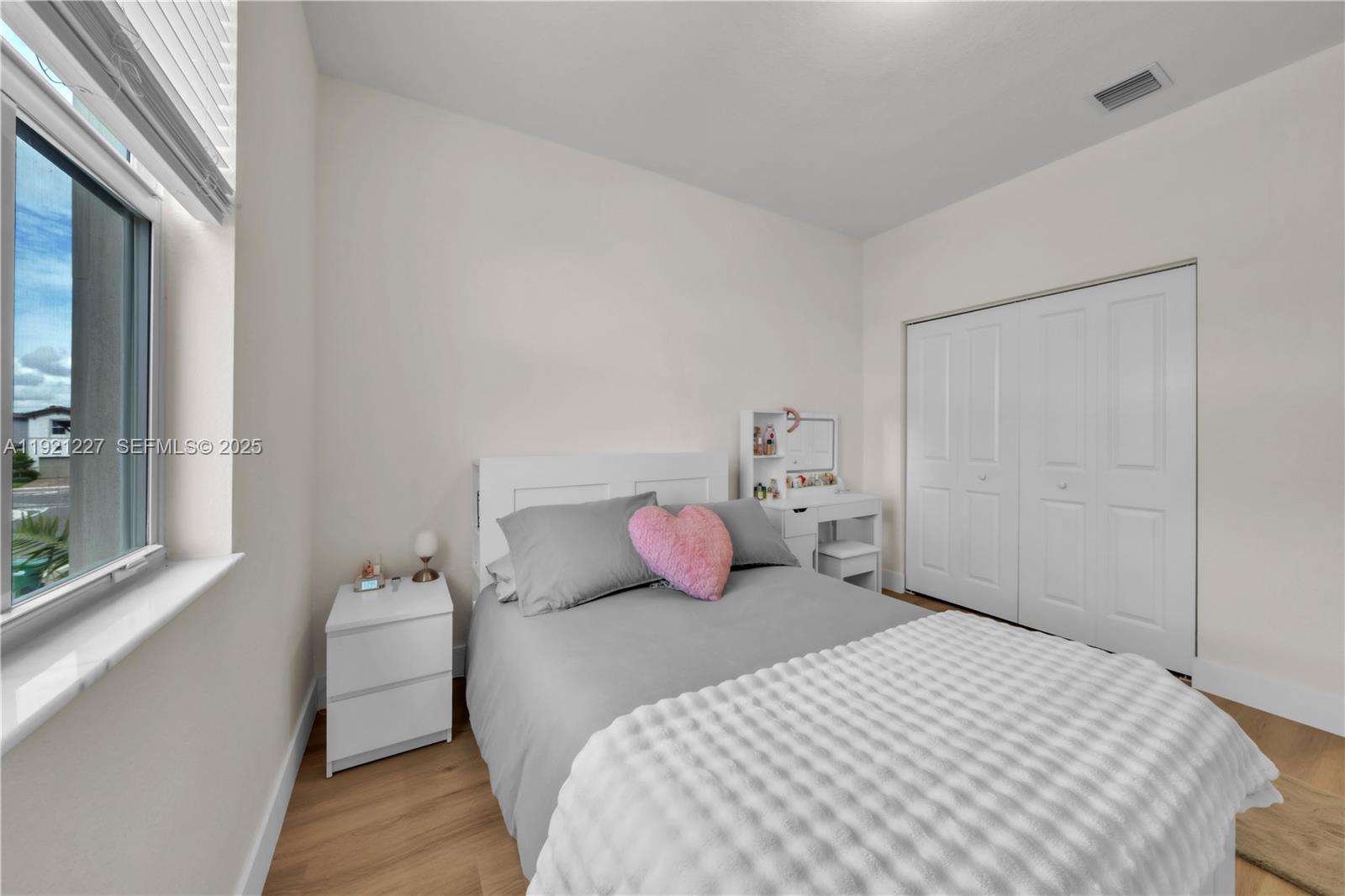 12917 Northwest 23rd Place Miami, FL 33147 - Photo 30 of 43 a bedroom with a bed and a window