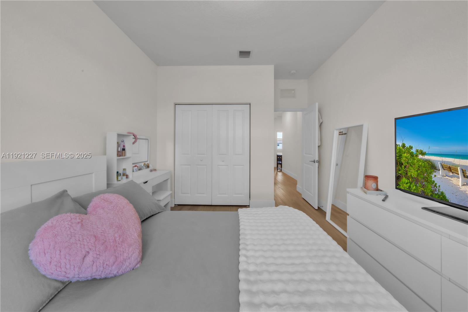 12917 Northwest 23rd Place Miami, FL 33147 - Photo 31 of 43 a bedroom with a bed and a large window