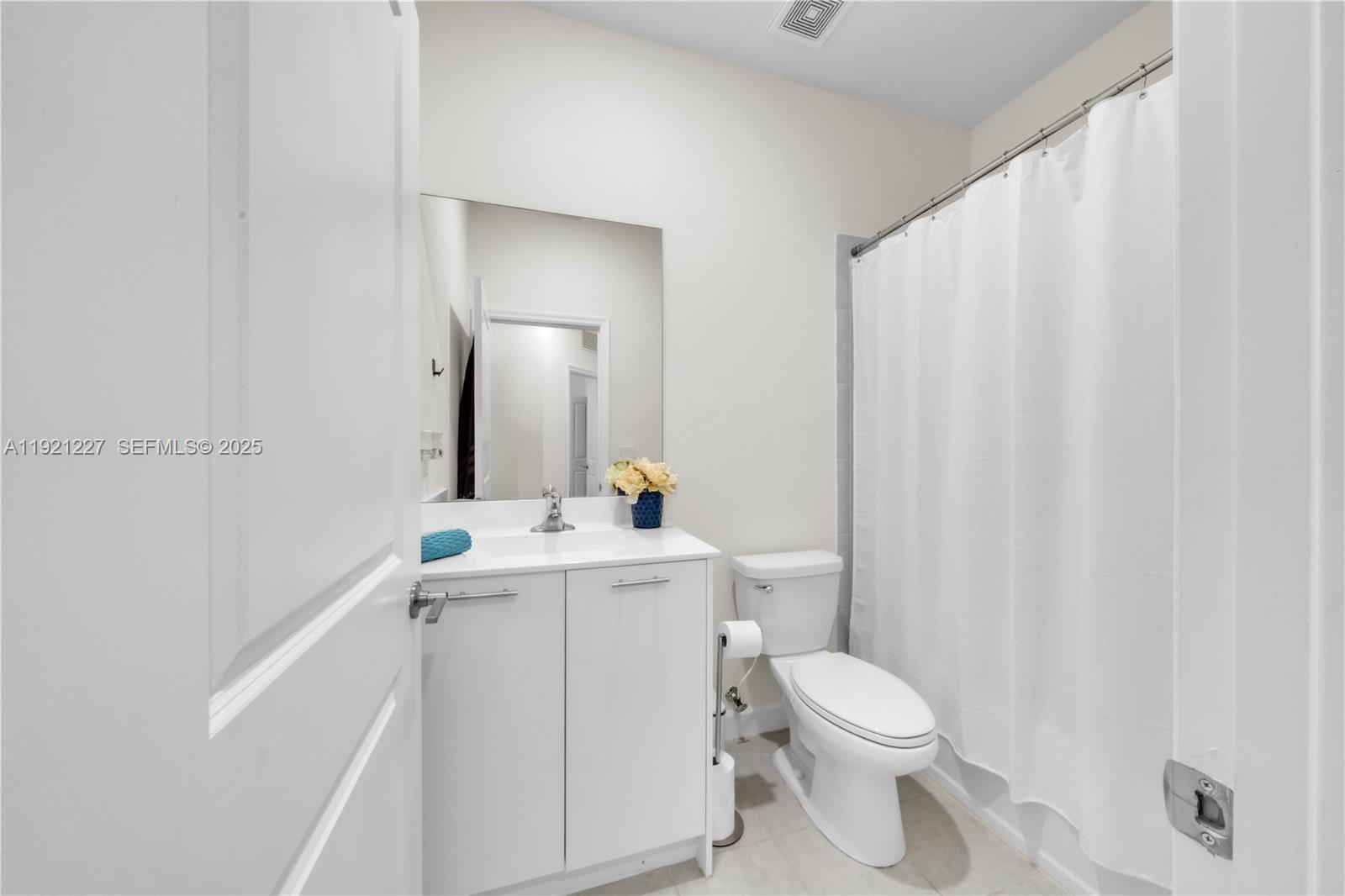 12917 Northwest 23rd Place Miami, FL 33147 - Photo 32 of 43 a bathroom with a toilet a sink and a mirror