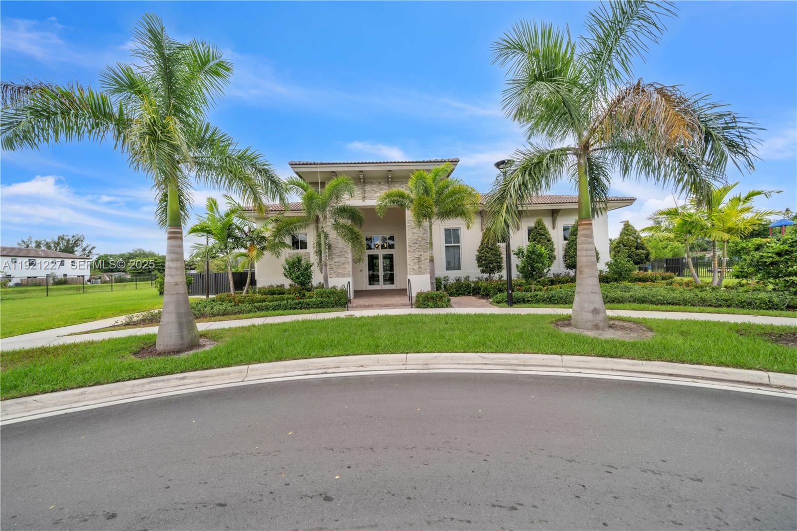 12917 Northwest 23rd Place Miami, FL 33147 - Photo 34 of 43 a view of a house with a big yard and palm trees