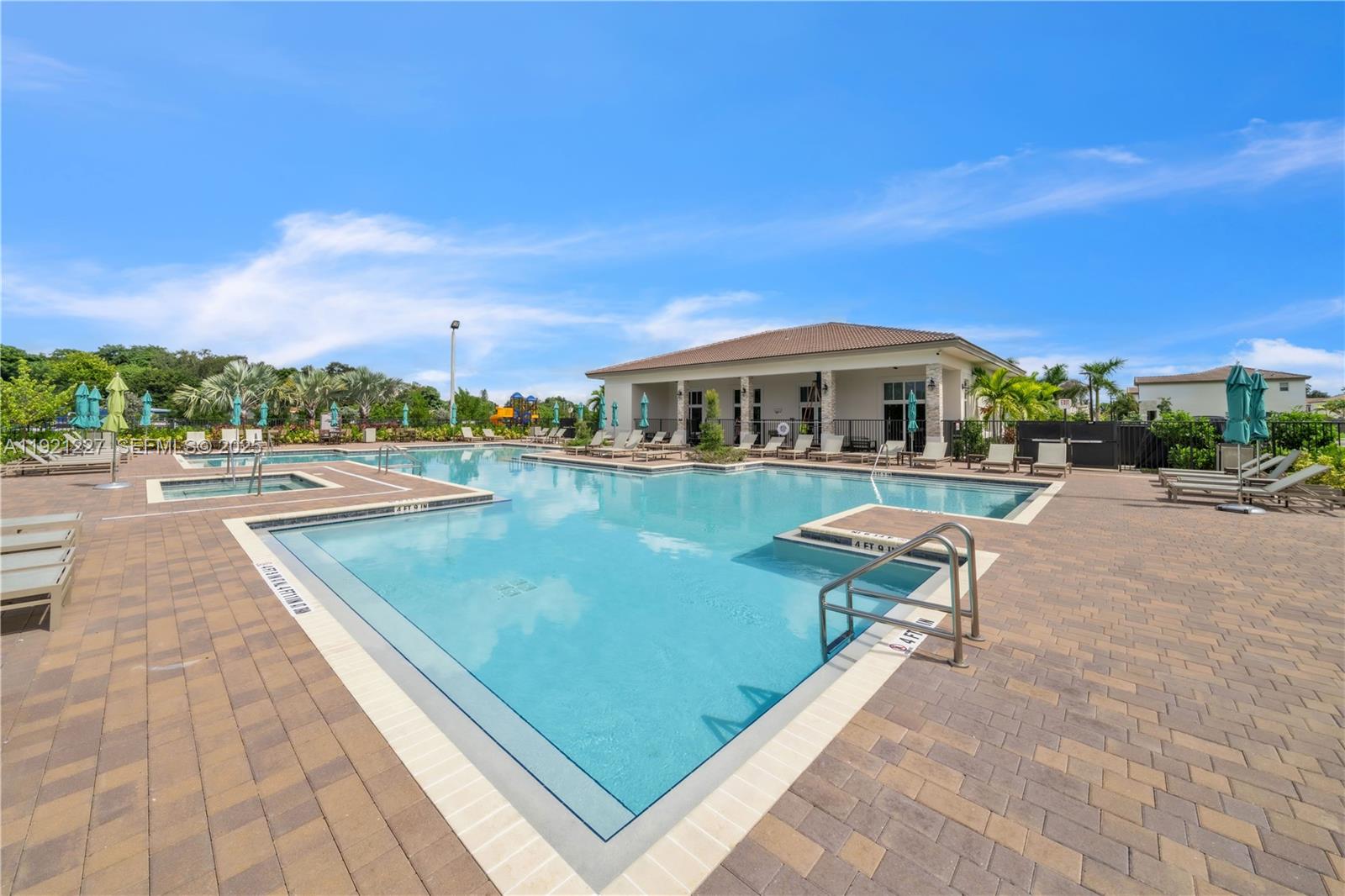 12917 Northwest 23rd Place Miami, FL 33147 - Photo 35 of 43 a view of a swimming pool with lawn chairs and a yard
