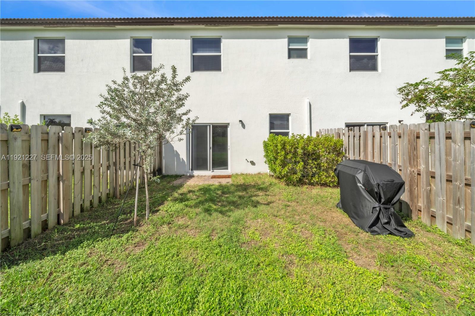 12917 Northwest 23rd Place Miami, FL 33147 - Photo 6 of 43 a backyard of a house with table and chairs