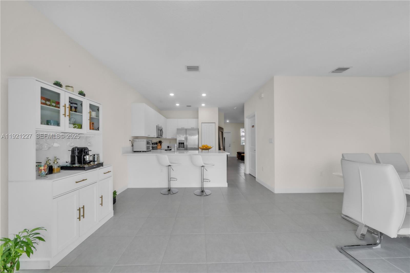 12917 Northwest 23rd Place Miami, FL 33147 - Photo 10 of 43 a kitchen with white cabinets and white appliances