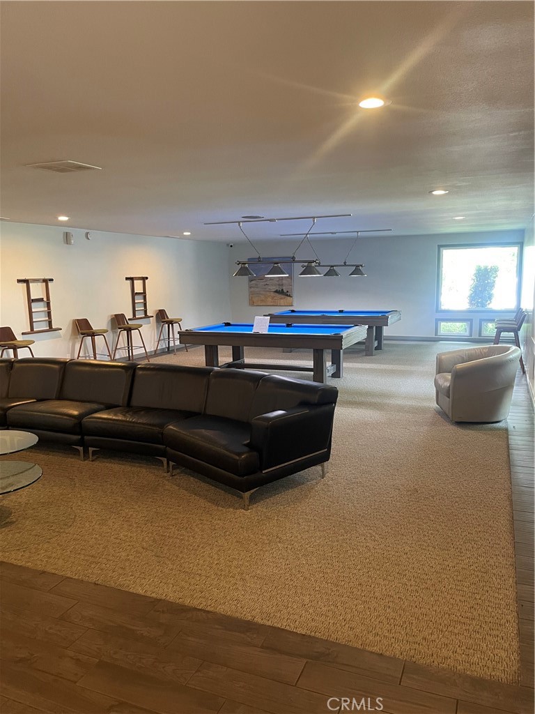 1550 Rimpau, Unit 147 Corona, CA 92881 - Photo 15 of 17 a living room with furniture a flat screen tv and kitchen view
