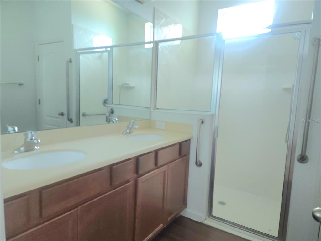 3230 Stratton Circle Kissimmee, FL 34744 - Photo 16 of 28 a bathroom with a sink and a mirror