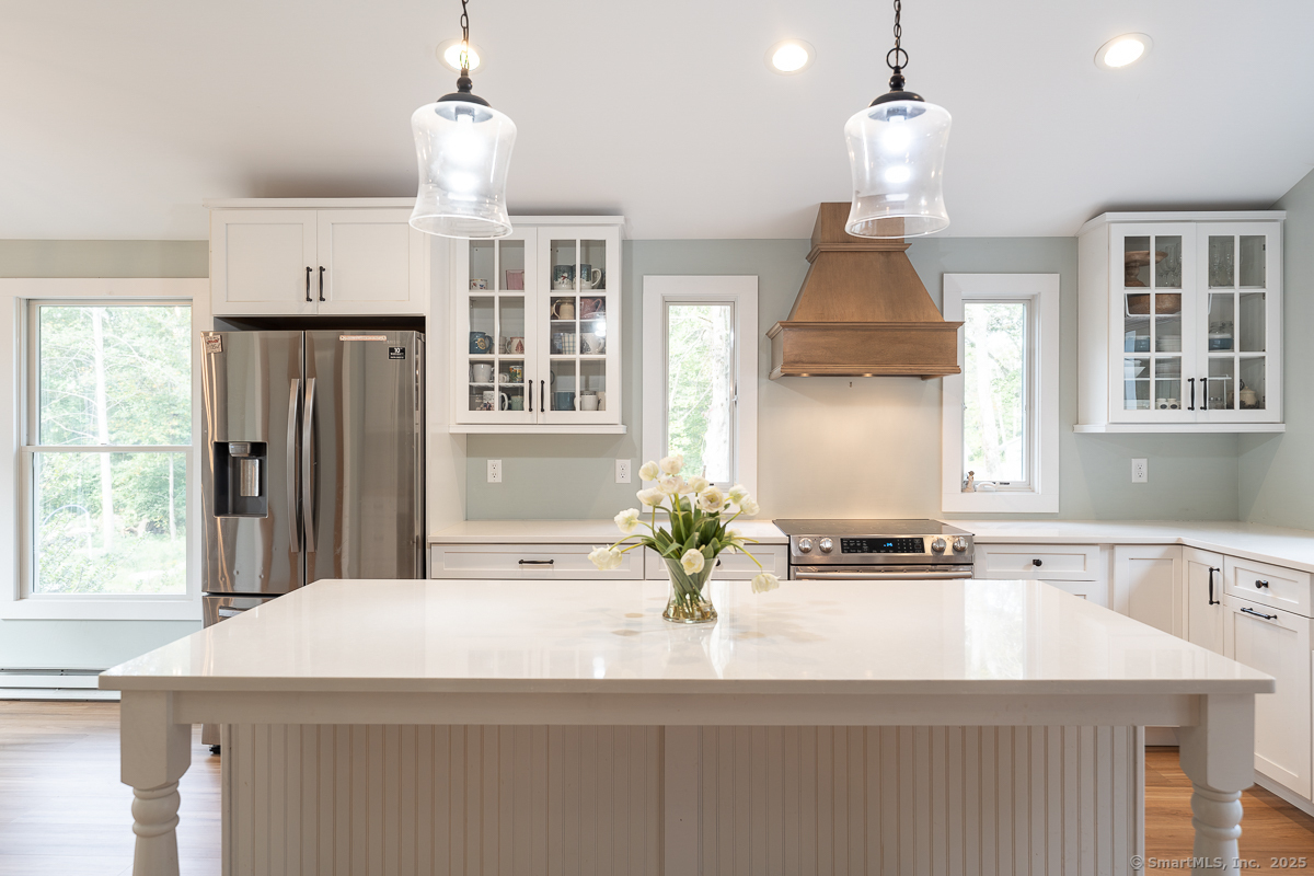 147 Pequot Avenue Groton, CT 06355 - Photo 14 of 40 Expansive center island with quartz counter top. Overhang ideal for additional seating for casual dining.