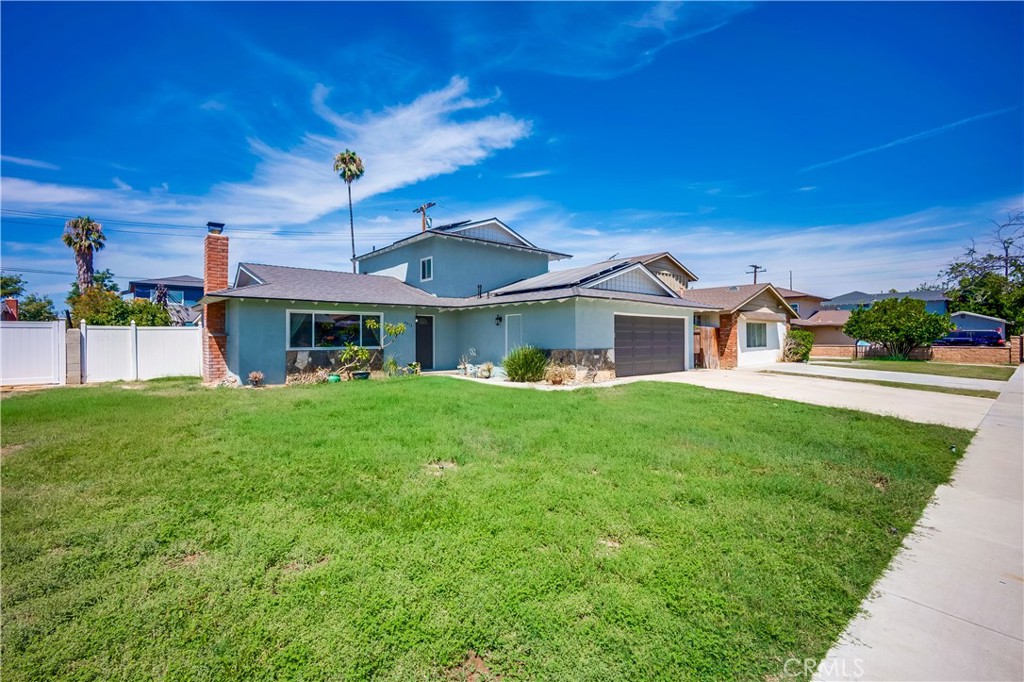 6473 Capistrano Way Riverside, CA 92504 - Photo 1 of 28 a front view of a house with a yard