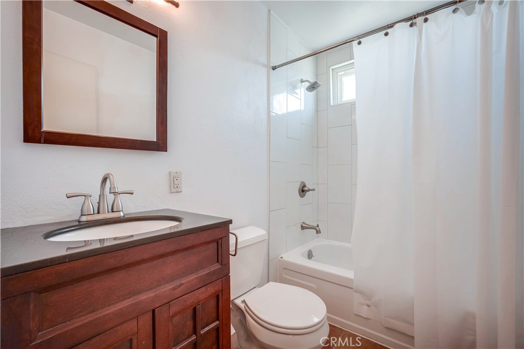 6473 Capistrano Way Riverside, CA 92504 - Photo 26 of 28 a bathroom with a sink a toilet and shower