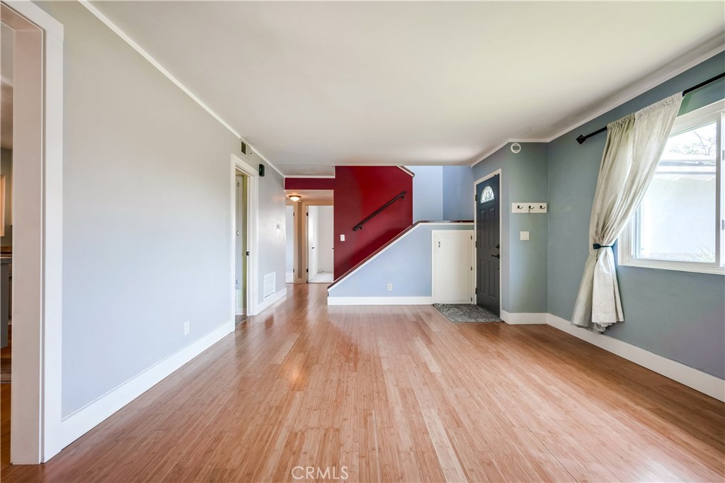 6473 Capistrano Way Riverside, CA 92504 - Photo 5 of 28 a view of an empty room with wooden floor and a window