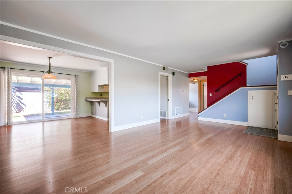 6473 Capistrano Way Riverside, CA 92504 - Photo 7 of 28 a view of an empty room with wooden floor and a window