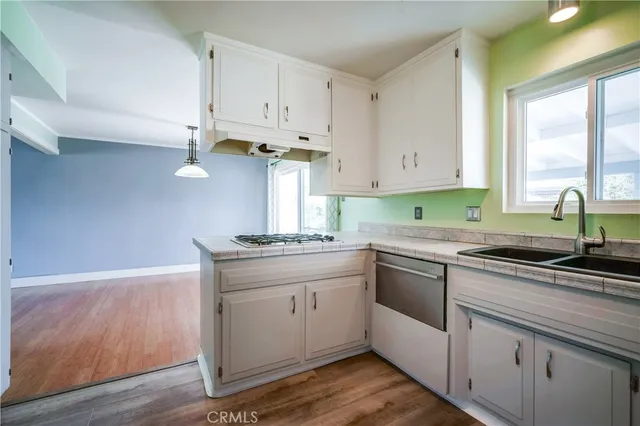 a kitchen with granite countertop a sink and cabinets