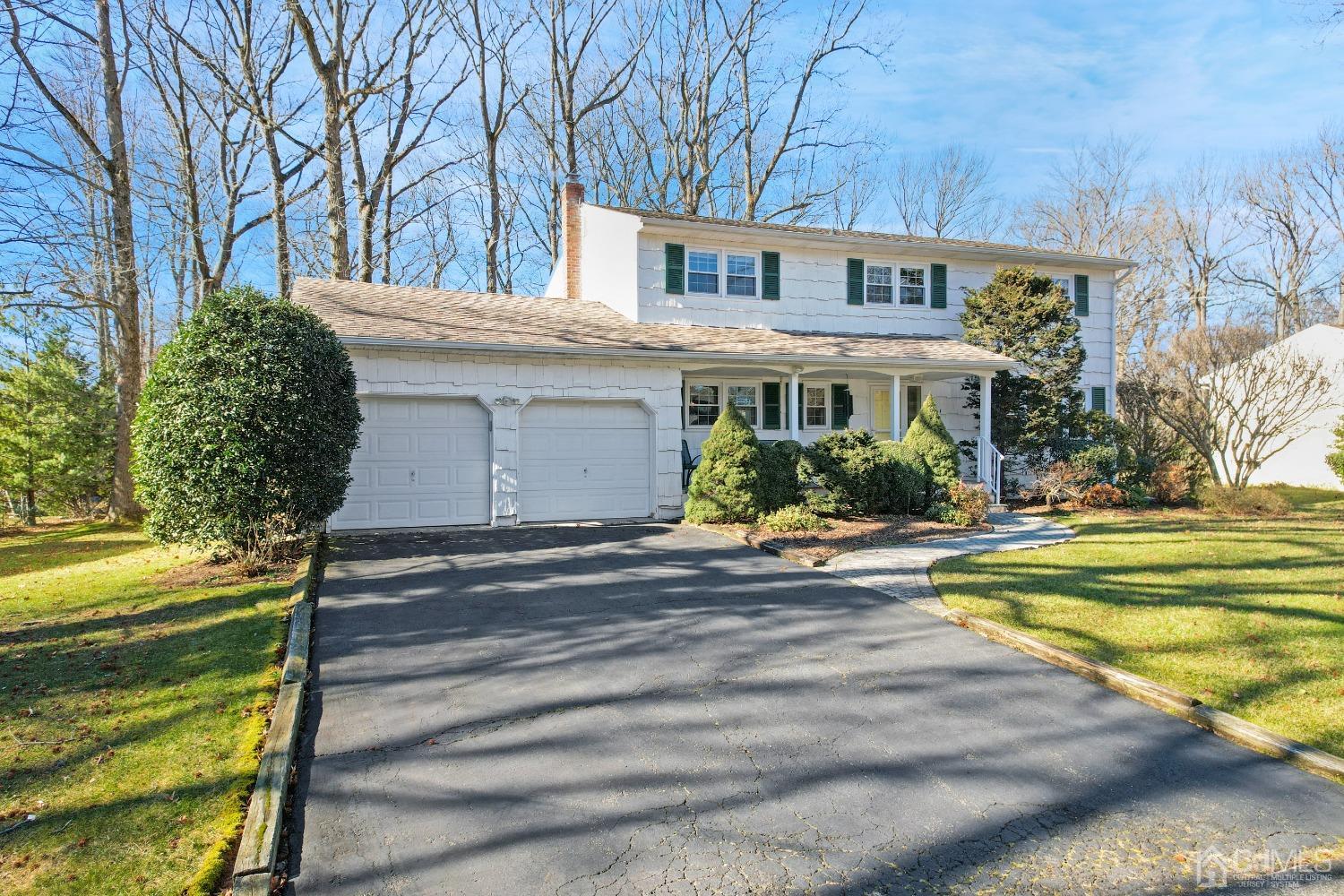 19 Warwick Road Edison, NJ 08820 - Photo 3 of 43 a front view of a house with a yard and a garage