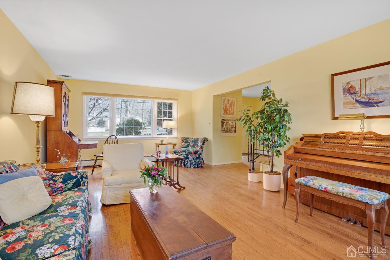 19 Warwick Road Edison, NJ 08820 - Photo 8 of 43 a living room with furniture and a floor to ceiling window