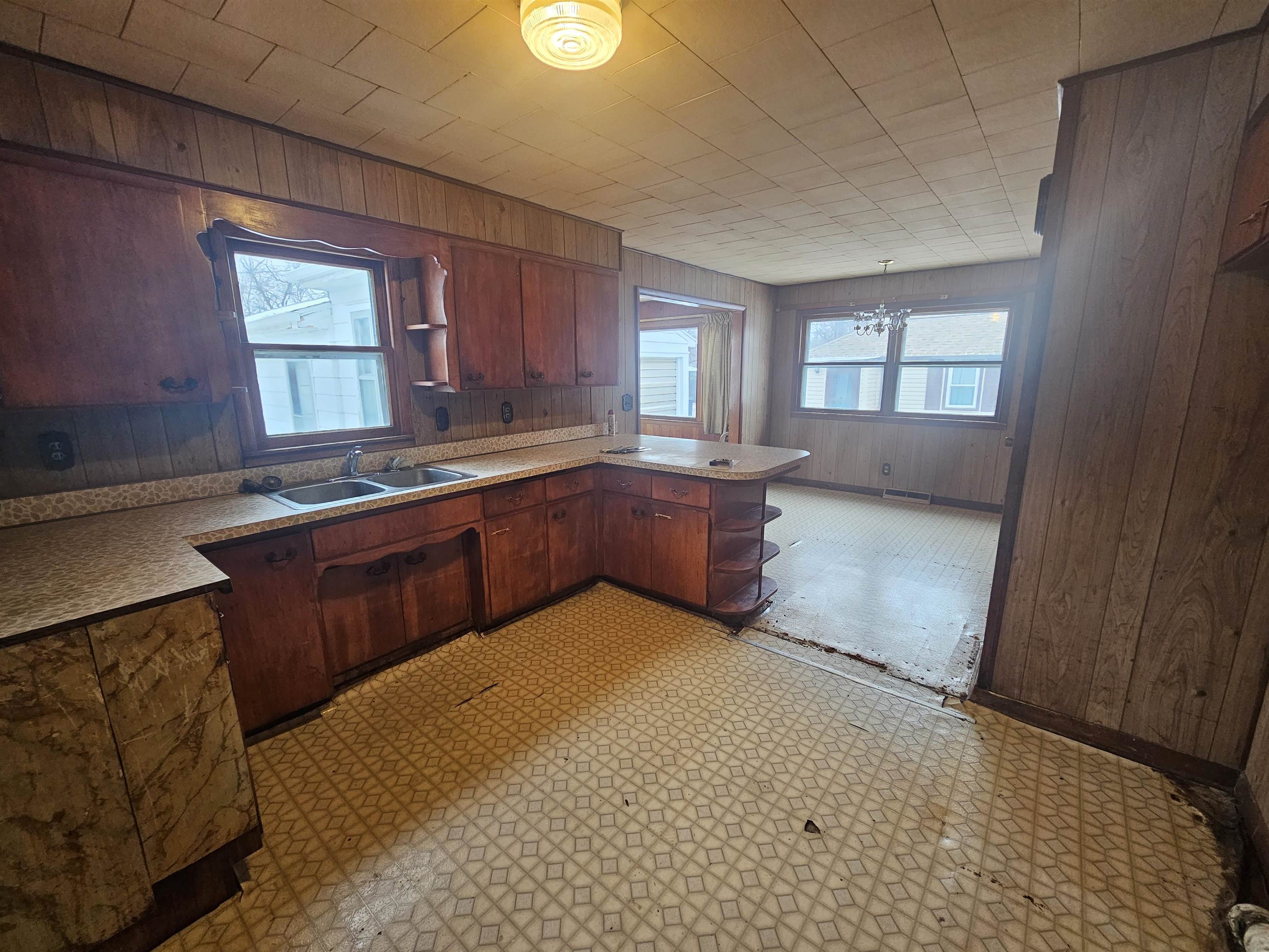 907 Merrill Avenue Loves Park, IL 61111 - Photo 13 of 15 a large kitchen with stainless steel appliances granite countertop a sink dishwasher stove and cabinets with wooden floor
