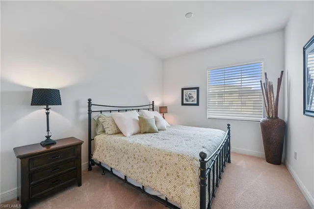 a bedroom with a bed and a lamp on table