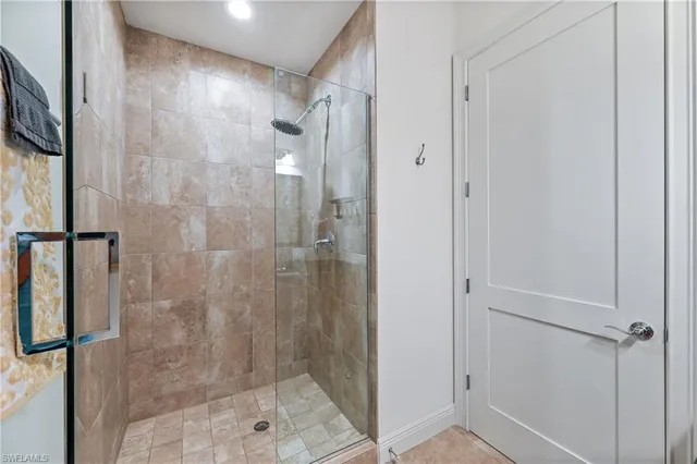 a bathroom with a shower and a glass door