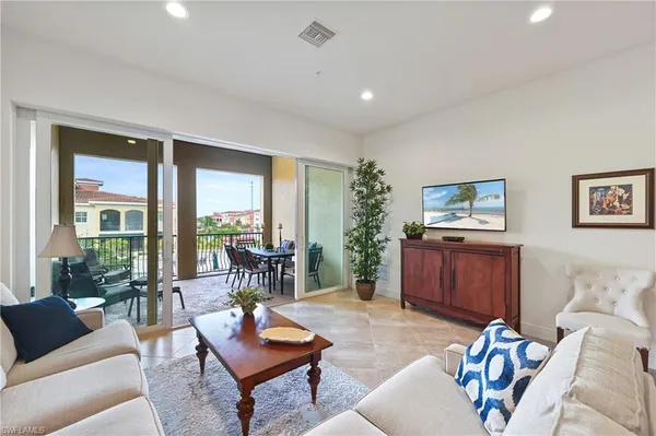 a living room with furniture and a flat screen tv