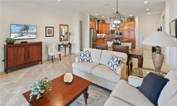 a living room with furniture and a chandelier