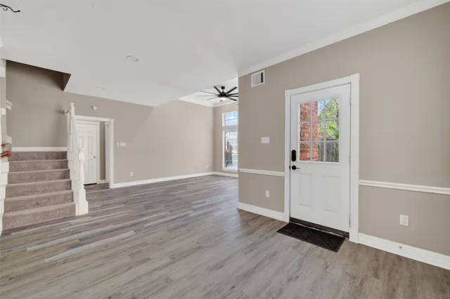 a view of a hallway with wooden floor and closet