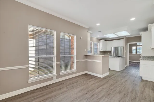 a view of kitchen and wooden floors