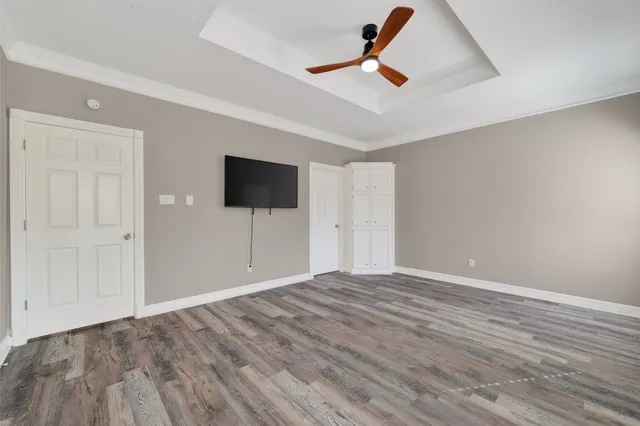 a large white bathroom with a granite countertop double vanity sink a mirror and a shower