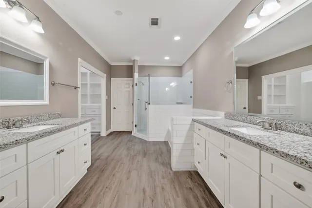 a bathroom with a double vanity sink and mirror