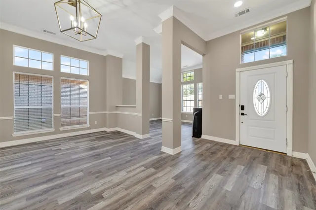 a view of wooden floor and windows in a room