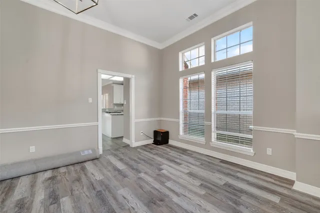 a view of a livingroom with wooden floor and a window