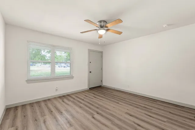 wooden floor in an empty room with a window
