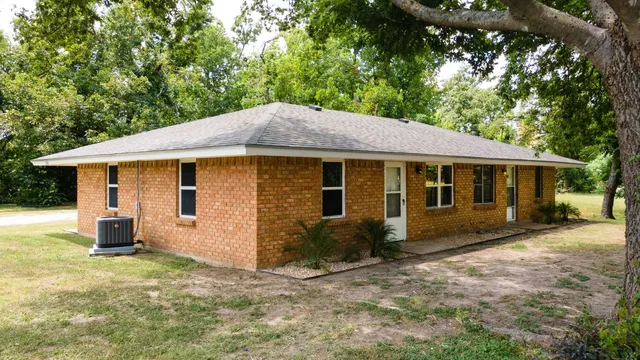 a view of a house with a yard and sitting area
