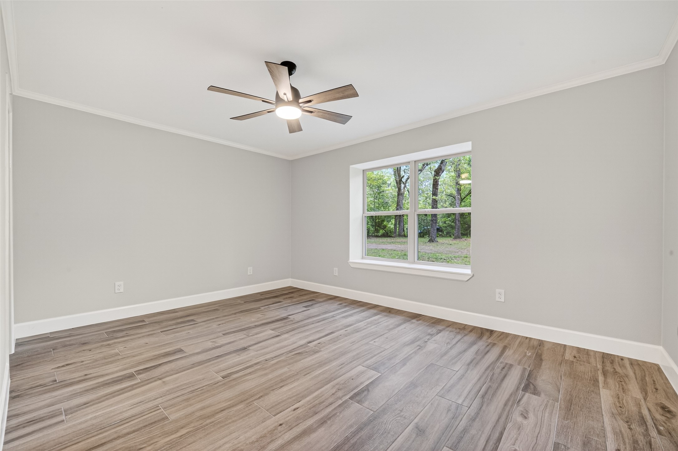 23607 Cardinal Drive Hockley, TX 77447 - Photo 27 of 50 This secondary downstairs bedroom has elegant crown molding and ample square footage, adapting easily to guests or a high-end home office.