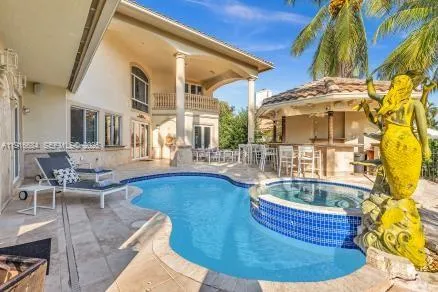 a living room with fireplace furniture and a large window