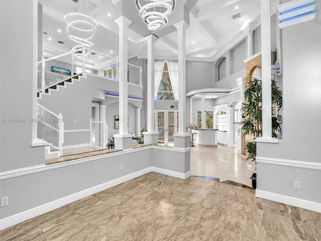 a kitchen with a refrigerator and white cabinets