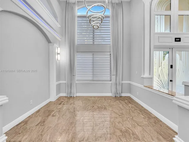 a kitchen with stainless steel appliances kitchen island granite countertop a refrigerator and a sink
