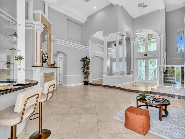 a room with pool table and windows