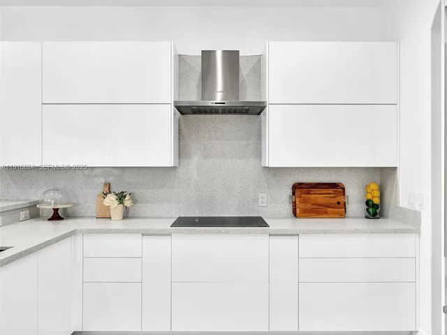a bedroom with a bed a mirror and tv on the dresser