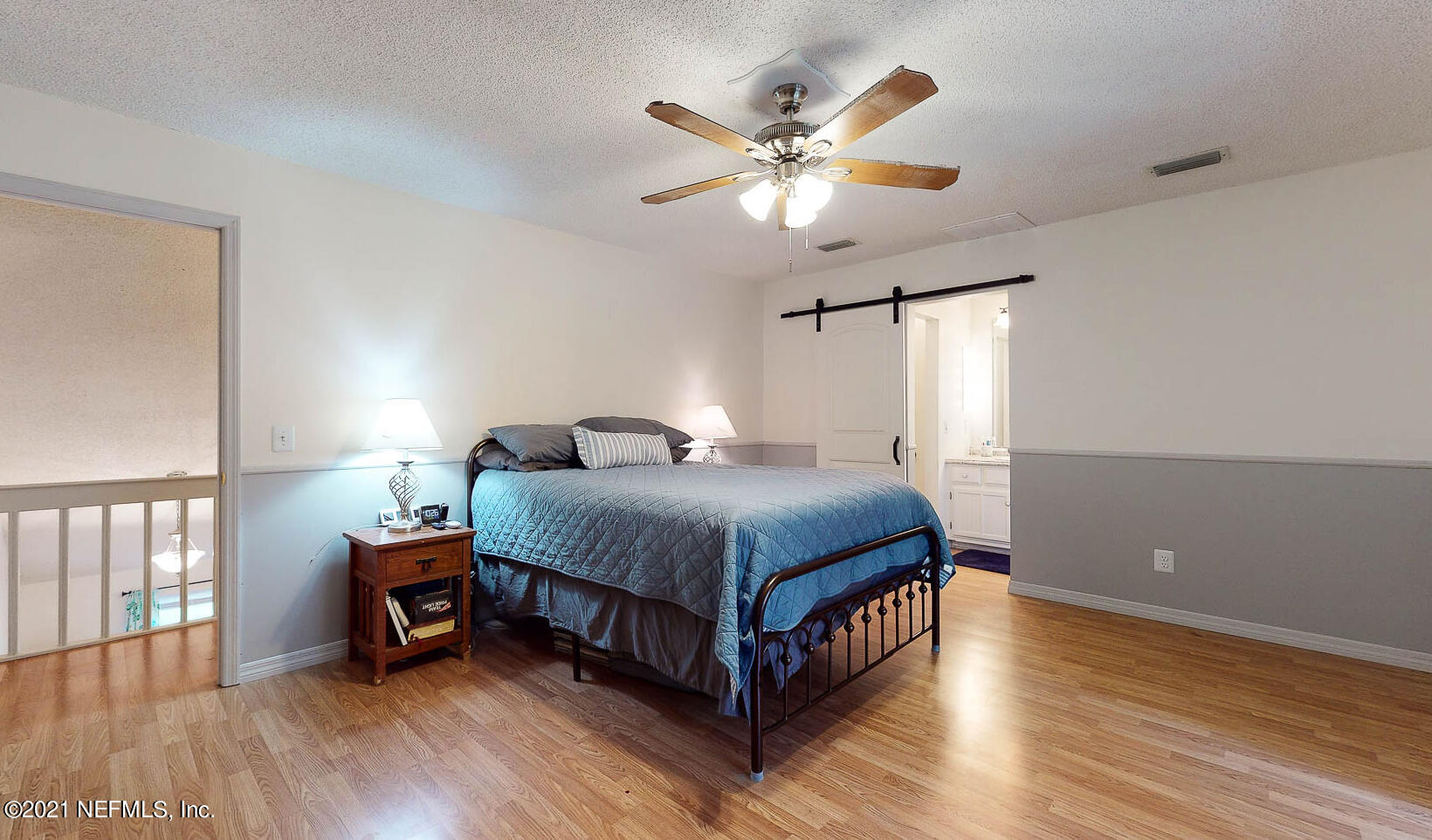 2053 Cornell Road Middleburg, FL 32068 - Photo 14 of 38 a spacious bedroom with a bed and a chandelier