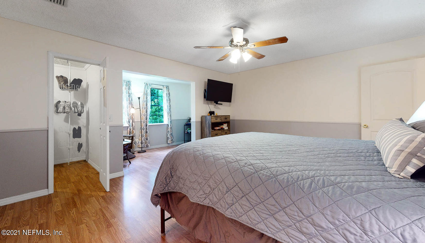 2053 Cornell Road Middleburg, FL 32068 - Photo 15 of 38 a bedroom with a bed and a chandelier
