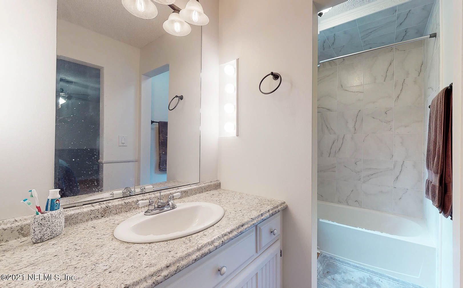2053 Cornell Road Middleburg, FL 32068 - Photo 17 of 38 a bathroom with a granite countertop tub sink and mirror