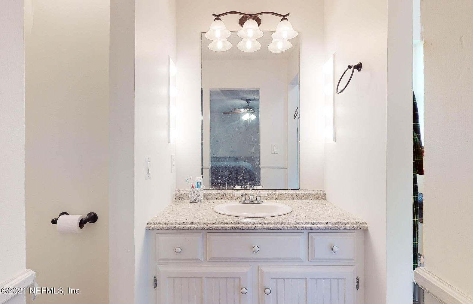 2053 Cornell Road Middleburg, FL 32068 - Photo 18 of 38 a bathroom with a granite countertop sink a mirror and a vanity