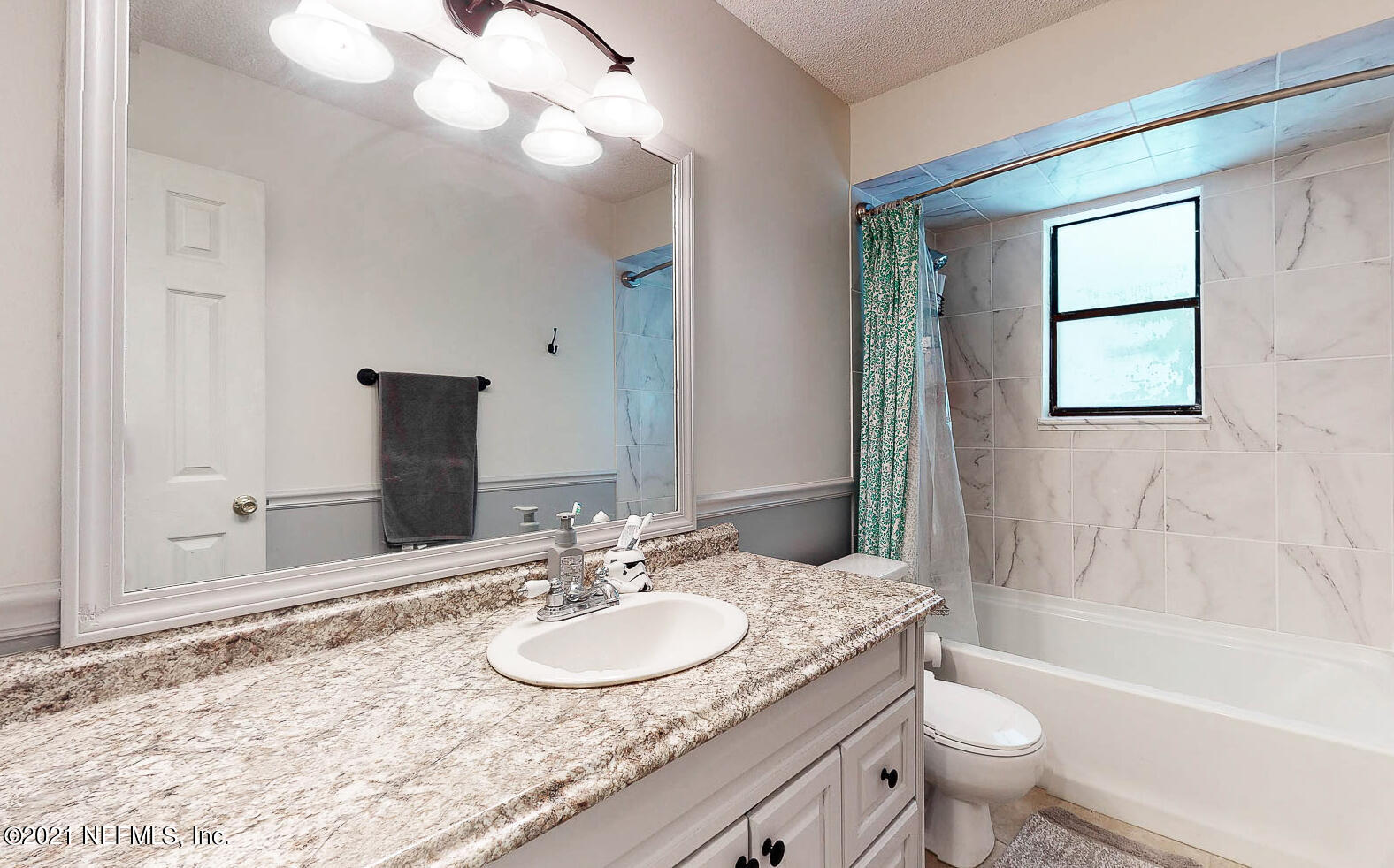 2053 Cornell Road Middleburg, FL 32068 - Photo 21 of 38 a bathroom with a granite countertop sink toilet and shower