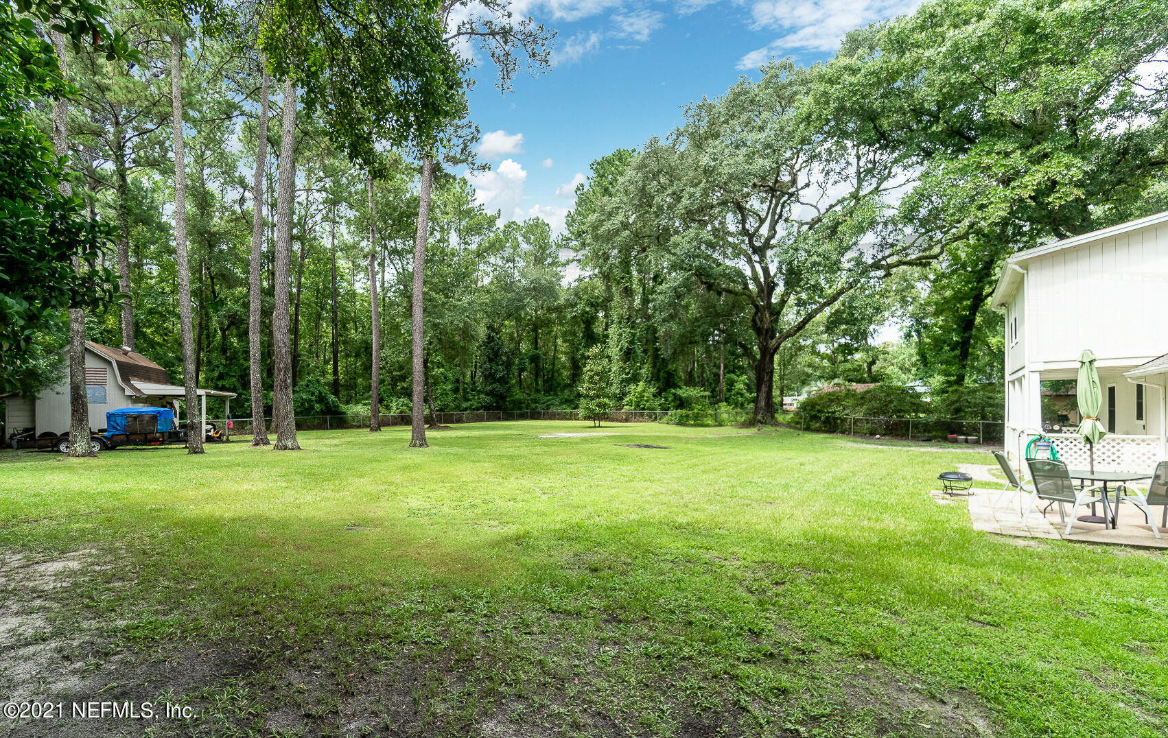 2053 Cornell Road Middleburg, FL 32068 - Photo 30 of 38 a view of a big yard with a house and large trees with wooden fence