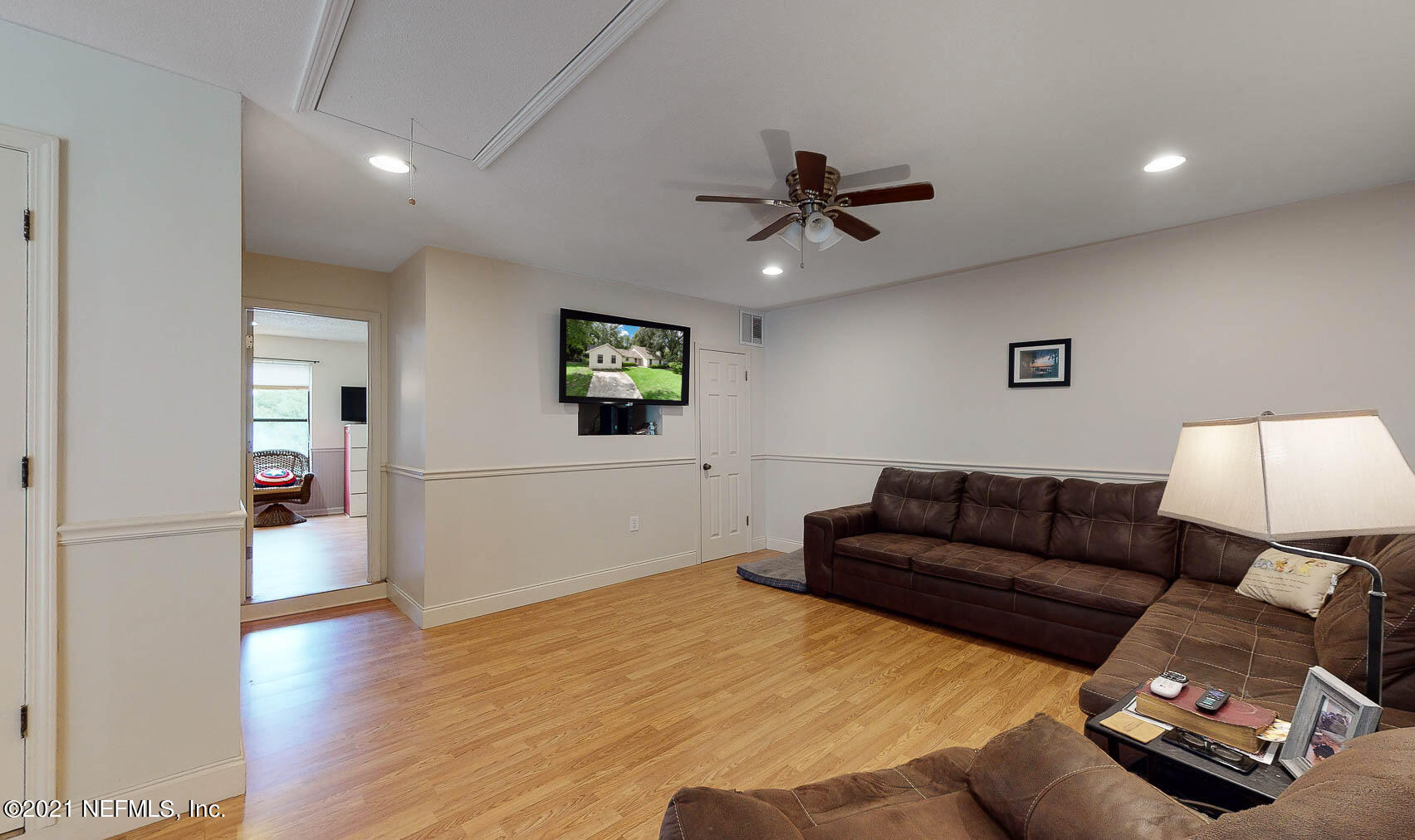 2053 Cornell Road Middleburg, FL 32068 - Photo 3 of 38 a living room with furniture and a flat screen tv