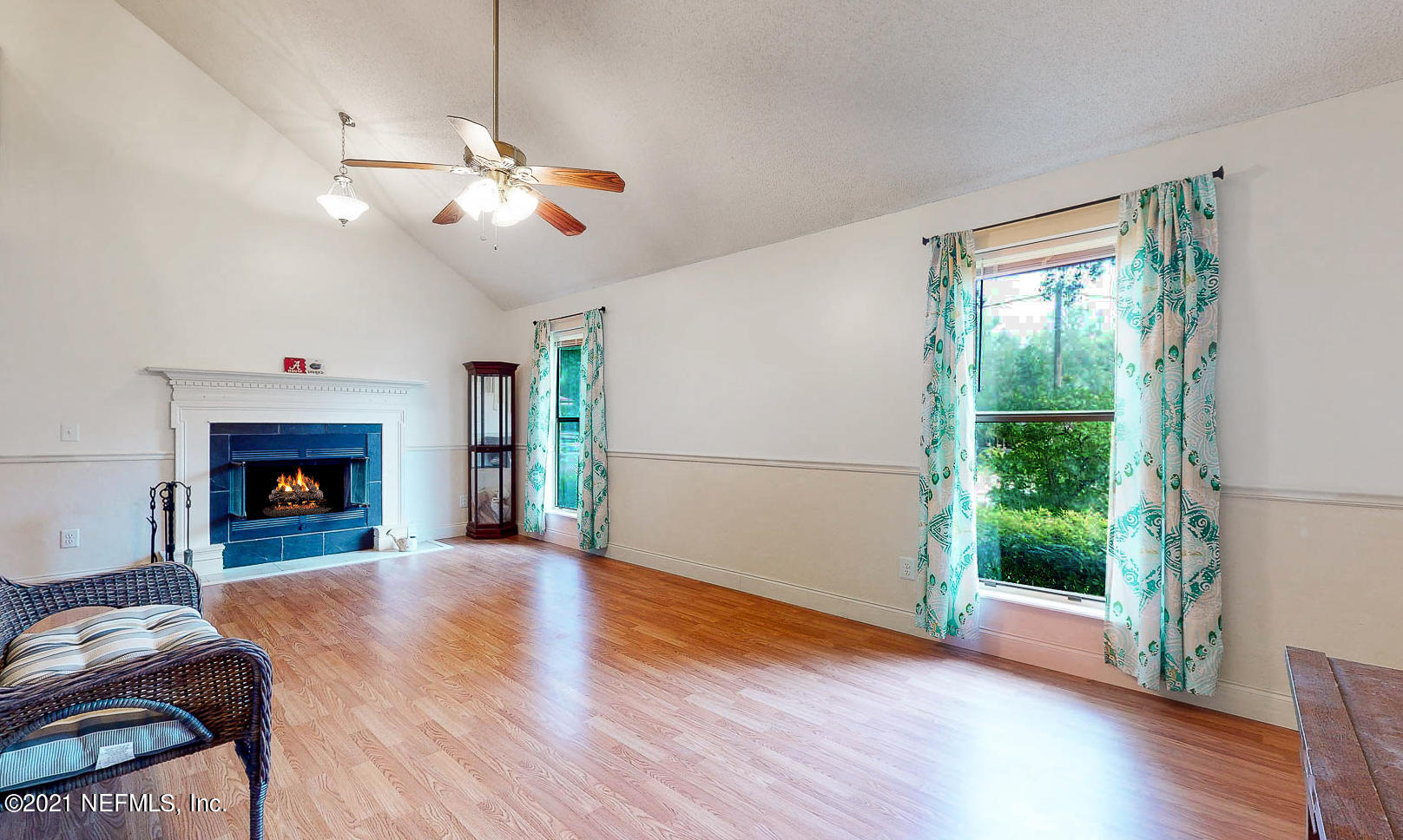 2053 Cornell Road Middleburg, FL 32068 - Photo 8 of 38 a view of a livingroom with a fireplace wooden floor and chandelier