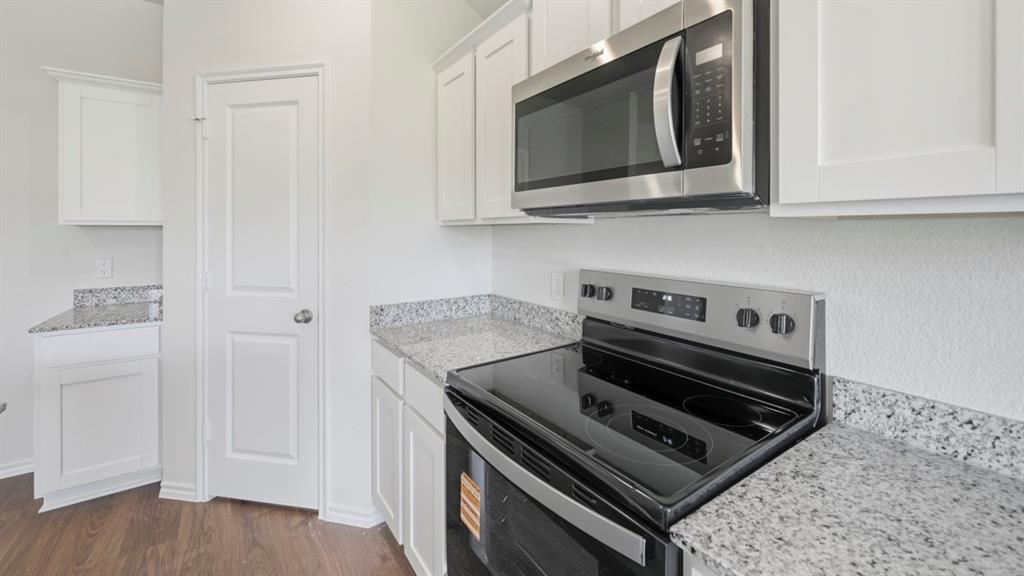508 Wild Rose Way Princeton, TX 75407 - Photo 22 of 33 a stove top oven sitting inside of a kitchen